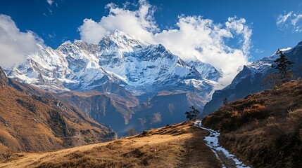 Majestic snow-capped mountains rise above a scenic valley, showcasing natural beauty and breathtaking landscapes under a clear blue sky.