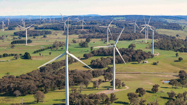 Aerial drone view of an array of large wind turbines at Biala and Gullen Range Wind Farm, Bannister in the Southern Tablelands region of New South Wales, Australia on a sunny day 