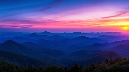 Obraz premium Stunning view of a mountain range at sunset with colorful clouds.