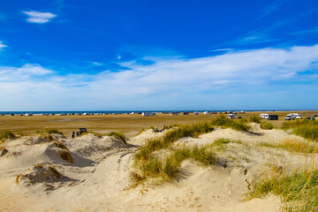 a popular, beautiful travel destination with cars, campers in the North Sea on the island of Rømø in Denmark
