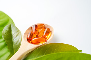wooden spoon with soft gels, Fish oil capsules, omega 3, omega 9, vitamin D, vitamin E