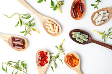 Vitamin capsules in a wooden spoon, soft gels, Fish oil capsules, omega 3, omega 9, vitamin D,...