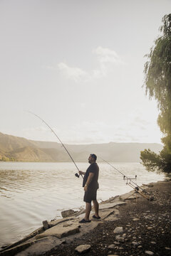 Fisherman fishing on a lake during a sunny day