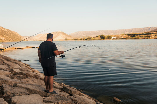 Fisherman fishing on a lake during a sunny day