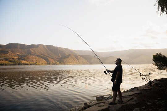 Fisherman fishing on a lake during a sunny day