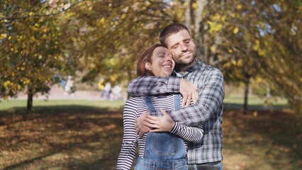 Fototapeta premium Happy married couple husband and wife portrait in city park