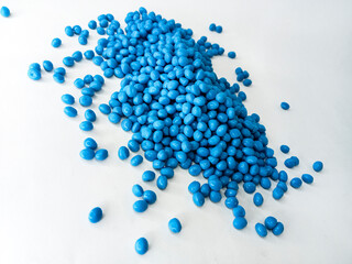 Hot cutting type masterbatch granules, blue plastic raw material resin coloring pigment granules, isolated with full color background for industrial plastic company profile product catalog design