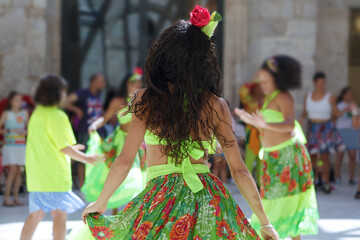 Dancers dancing and wearing one of the traditional folk costume from Brazil