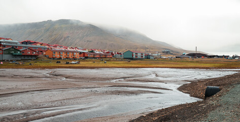 A view of Longyearbyen in Svalbard showcasing colorful houses against a cloudy backdrop