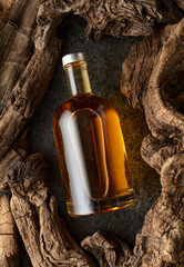 Bottle of whiskey and old dried snags.
