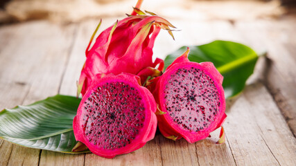 Dragon fruit with leaf on wooden background