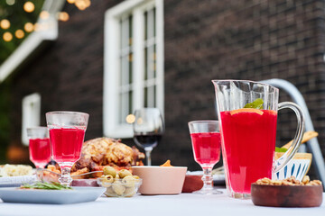 Close up background image of colorful lemonade drinks on table served for dinner party outdoors no people copy space