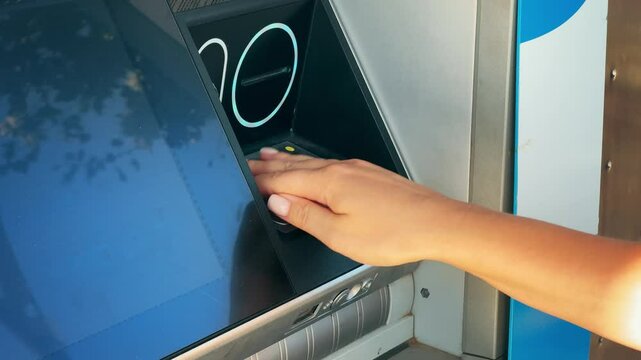 ATM Banking. Enter pin code in cash machine. Close up of person typing personal pin code in ATM cash machine.