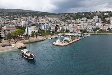 Sarande town Albania,Ionian Sea coast is renowned for its stunning landscapes and vibrant atmosphere.Aerial panorama views of the city reveal a picturesque blend of turquoise waters, sandy beaches