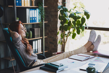 Photo of happy charming lady assistant wear formal shirt arms behind head having rest indoors...