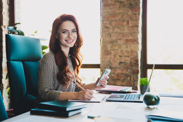 Photo of smiling positive lady boss formalwear texting modern device writing book indoors workplace...