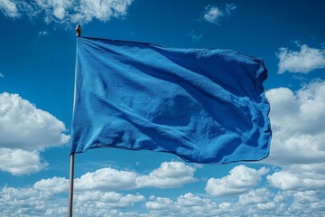 Vibrant blue flag against a cloudy sky