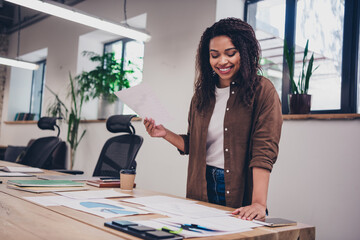 Photo of successful young business woman hold paper document desk wear shirt modern business center office indoors