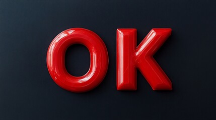 2410 42.Red plastic blocks forming the letters "OK" against a black background, with each block clearly visible and connected in a sturdy, structured arrangement. The contrast between the vibrant red