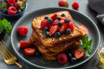 delicious french toasts with honey and fresh berries