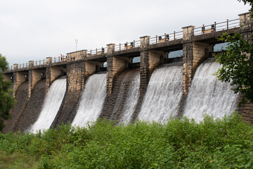 water releases from flood gate of topchachi dam with abundant green surrounding, jharkhand, india