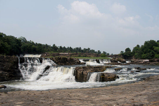 "bhatinda waterfalls" lies in river "katri"plunges down in tree steps surrounded by dense forest at jharkhand state, india