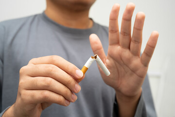 Quit smoking, Asian man breaking destroy cigarette in hand.