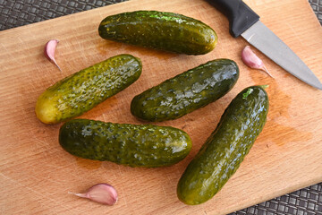 Lightly salted cucumbers on a chopping board