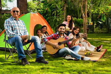 Indian family of six camping, playing music, singing, and capturing memories with a selfie