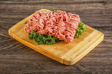 Raw pork minced meat over board