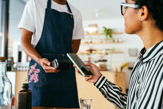 Bakery, happy portrait of black woman in cafe ready for serving pastry, coffee and baked foods. Restaurant, coffee shop and confident waiter barista by counter for service, help and welcome - Powered by Adobe
