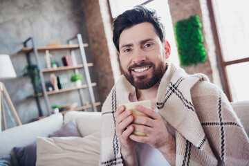 Photo of positive man wrapped plaid influenza treatment drinking hot tea indoors apartment