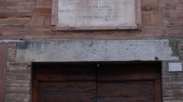 Commemorative plaque marking the birthplace of Pietro Vannucci in Citta della Pieve, Italy_tilt