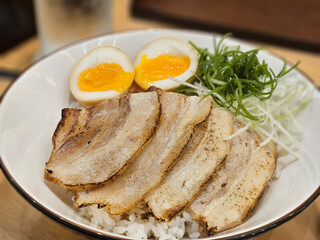 Close up of a chashu pork rice serving with boiled egg in Japanese cuisine