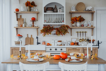 Cozy autumn kitchen with decorative pumpkins and seasonal foliage in a warm setting