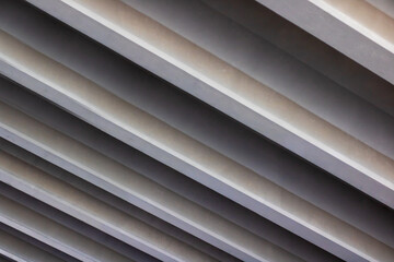 Obraz premium This is a detailed close up shot of a row of gray blinds installed on a ceiling
