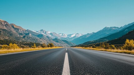 Empty asphalt road and mountains under clear sky
