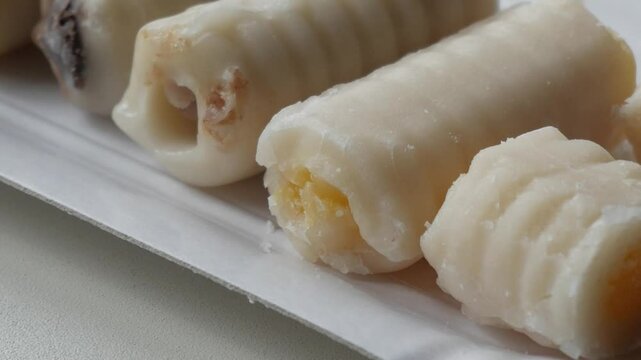 Tasty marzipan rolls close up with filling traditional for All Saints day in spain, Huesos de Santo