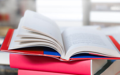 stack of books on the table. open book