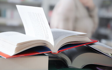 stack of books on the table. open book
