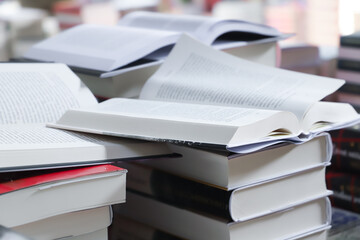 stack of books on the table. open book