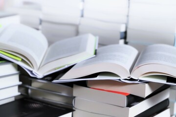 stack of books on the table. open book