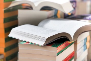 stack of books on the table. open book