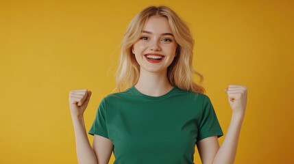 A woman wearing a green shirt raises her fists in defiance or passion, suitable for use as a symbol of empowerment or motivation