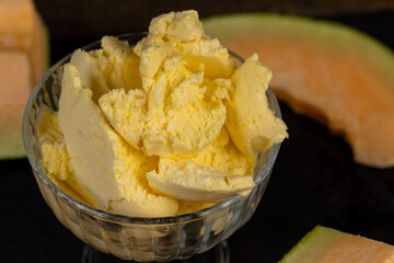 sweet creamy ice cream and pieces of melon on the table