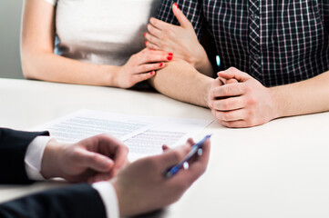Couple in meeting with notary, financial advisor or lawyer. Life insurance contract, bank loan...