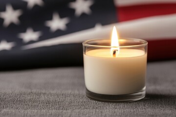 A simple candle burning in front of a flag, memorial candle, remembrance, honoring fallen veterans