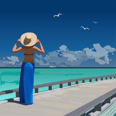 a girl in a blue pareo and a hat on the islands enjoys the sea
