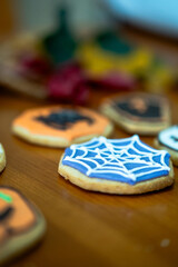 
Homemade Halloween-themed desserts. Various cakes containing the faces of different monsters of the Halloween holiday. Background containing autumn leaves.