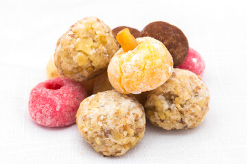 Panellets (typical sweet for All Saints' Day in Catalonia, the Balearic Islands, Levante and Aragon) on a white background.